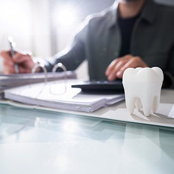 Patient in Dallas budgeting for dental implants