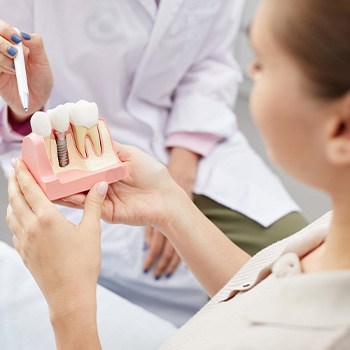 Dentist in Dallas showing patient dental implants