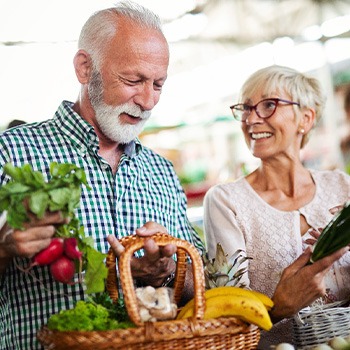 An older couple buying fresh foods