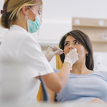 A woman receiving dental treatment for her gum disease