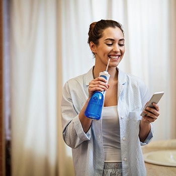 Dallas patient water flossing teeth after treatment