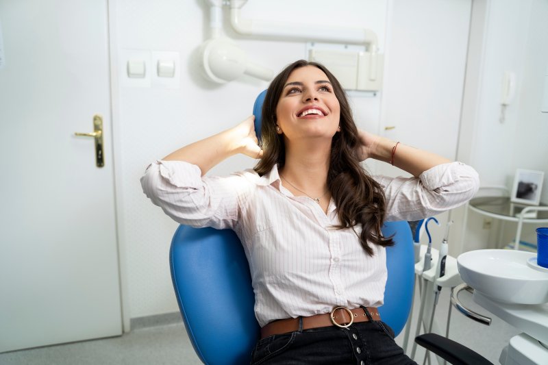 Patient smiling at the dentist after dental care